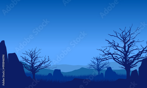 Fantastic mountain view with dry pine tree silhouette at night from the countryside