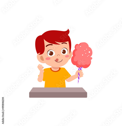 little boy eat sweet cotton candy and feel happy