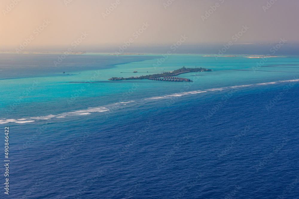 Fantastic aerial landscape, luxury tropical resort or hotel with water villas and beautiful beach scenic. Amazing bird eyes view in Maldives, landscape seascape aerial view over Maldives, traveling