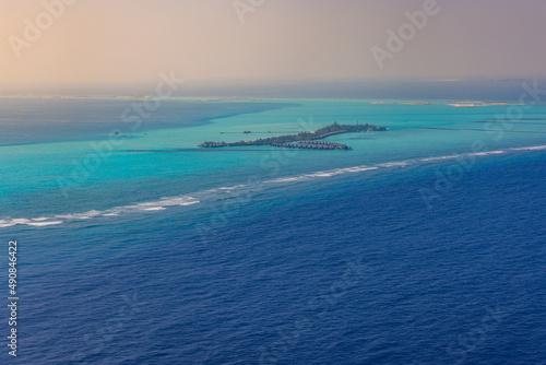 Fantastic aerial landscape, luxury tropical resort or hotel with water villas and beautiful beach scenic. Amazing bird eyes view in Maldives, landscape seascape aerial view over Maldives, traveling