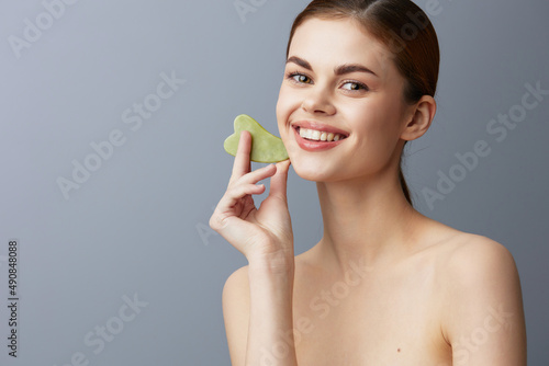 beautiful woman scraper gua sha facial care home facial massage isolated background