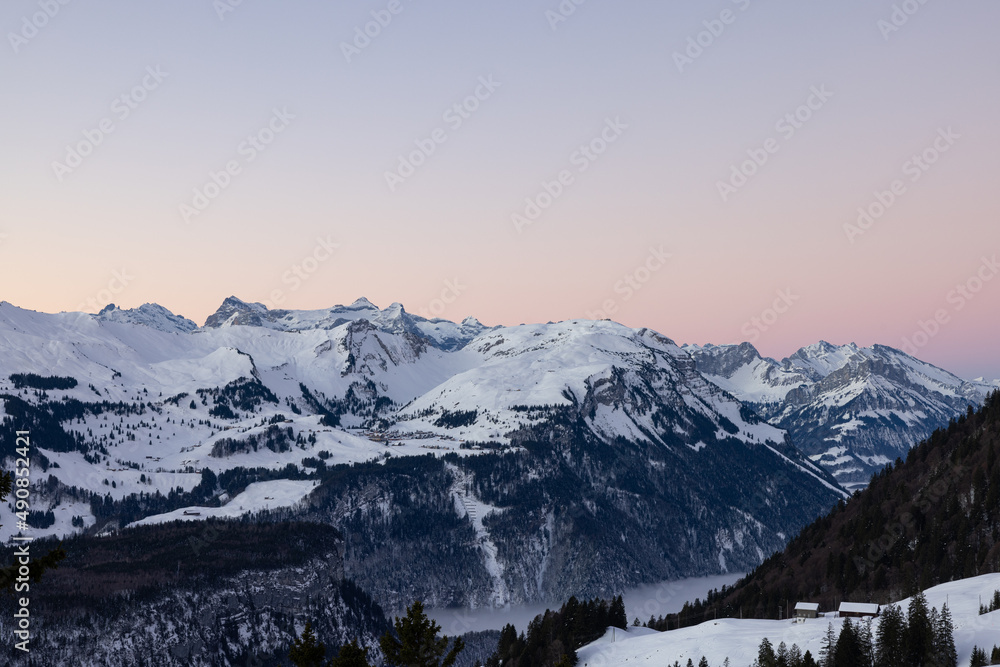 Amazing morning view and an epic sunrise with pink and blue tones. Epic long exposure shot in the heart of Switzerland. Wonderful scenery with the mountain called Grosser Mythen in the background.
