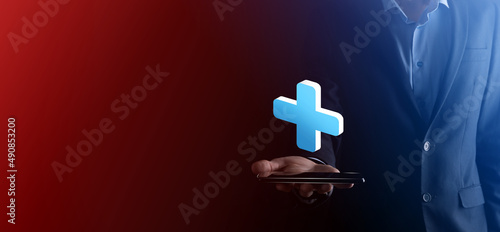 Fototapeta Naklejka Na Ścianę i Meble -  Businessman hold 3D plus icon, man hold in hand offer positive thing such as profit, benefits, development, CSR represented by plus sign.The hand shows the plus sign