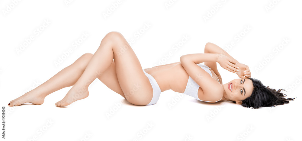 Fitness young woman with a beautiful body laying on white background Fitness young woman with a beautiful body laying on white background