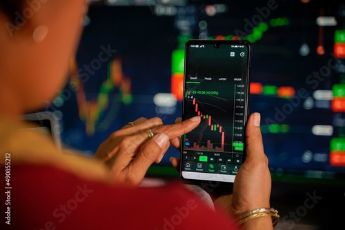 Traders looking at the stock chart with blurry chart background The concept of virtual currency
