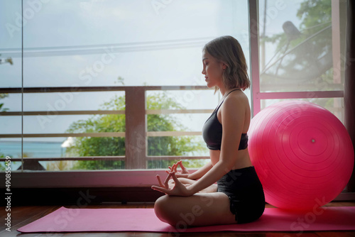 Free Download Young woman meditates while practicing yoga.Calmness and relax,health concept - GFXLoad
