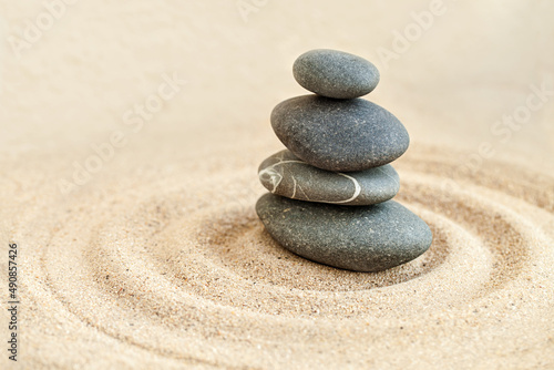 Sandy serenity. Shot of a stones stack in sand.