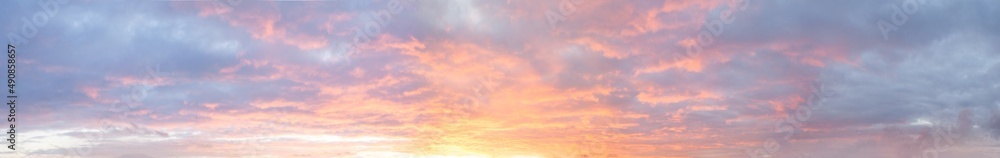 Panoramic bright colorful sunset sky with clouds, nature background