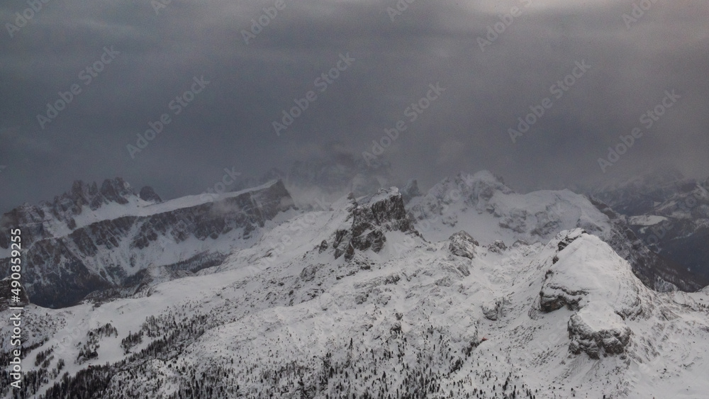 Stormy clouds in italian dolomites in a snowy winter