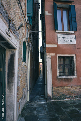 Detail of the Venetian houses with a very narrow alley. Fondamenta S. Giobbe, Venice, Italy. Vertical image. © JulyLo.Studio