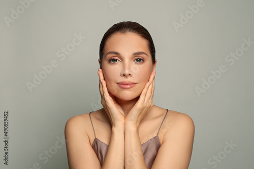 Facial treatment, skin care and beauty concept. Perfect young woman face with clear healthy skin