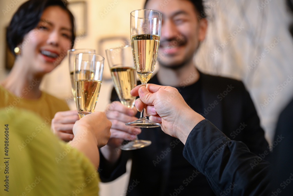 Image of a man and a woman toasting at a party, hand foreground blur, faceless, easy to use. Image of a man and a woman toasting at a party, hand foreground blur, faceless, easy to use.