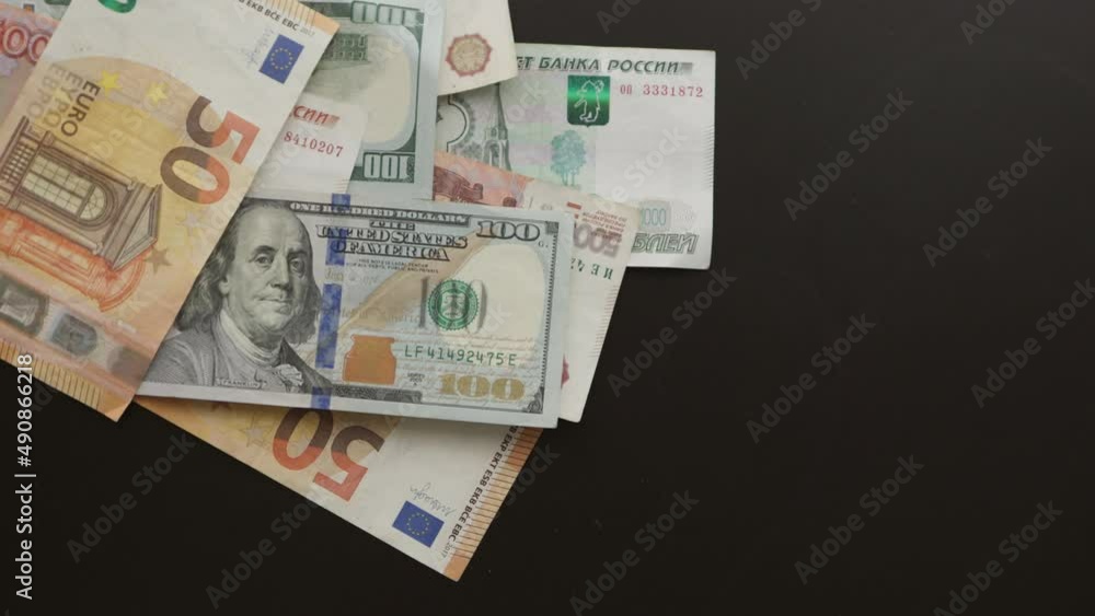 hand pulling throwing paper money euro dollar rouble banknotes on black table, falling Russian currency, European, US dollar bills, 50 euros, 100 euros, 5000 rubles, 2000 rubles, 1000 rubles, 100 usd hand pulling throwing paper money euro dollar rouble banknotes on black table, falling Russian currency, European, US dollar bills, 50 euros, 100 euros, 5000 rubles, 2000 rubles, 1000 rubles, 100 usd