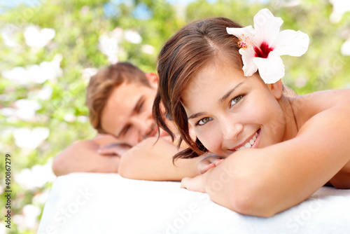 Enjoying being pampered together. Beautiful young woman enjoying a spa day with her partner.