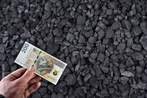 Polish currency showed on coal of mine deposit mineral resources background