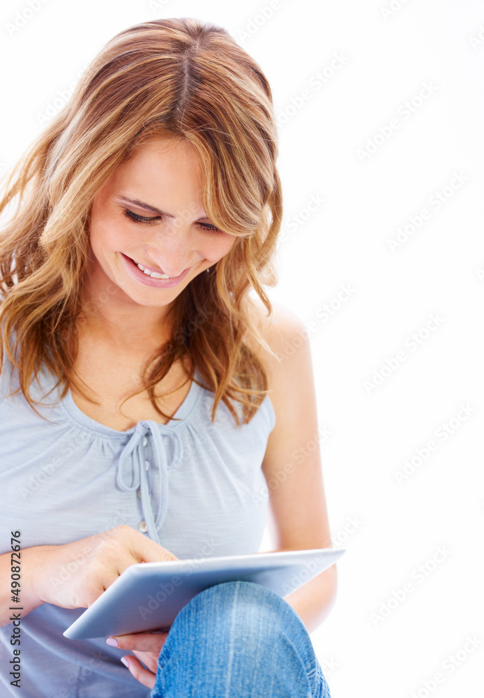 This tablets amazing. Young woman using her digital tablet with a smile. This tablets amazing. Young woman using her digital tablet with a smile.