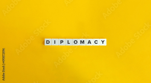 Diplomacy Word on Letter Tiles on Yellow Background. Minimal Aesthetics.