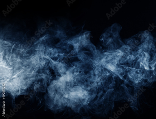 Abstract smoke texture over black. Fog in the darkness.
