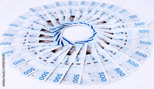 Photography Danish kroner money bills placed in a circle on a white desk
