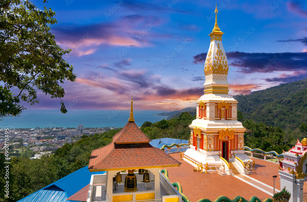 Naklejka premium Buddah temple with beautiful views from top of mountain of Patong Phuket Thailand. Buddha religious building with lovely colours in the sky