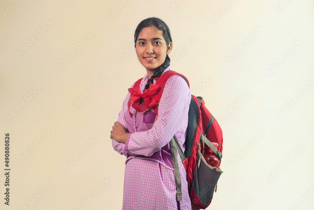 Portrait of a happy school girl standing front of camera with school bag Portrait of a happy school girl standing front of camera with school bag