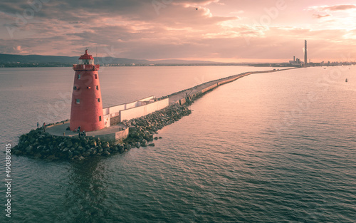 Obraz na płótnie Aerial view of Poolbeg Lighthouse the famous red landmark in Dublin Harbor Ireland seen by drone at sunset w salonie