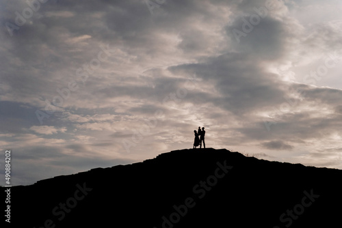 Family Silhouettes Standing Togetherness on Hill