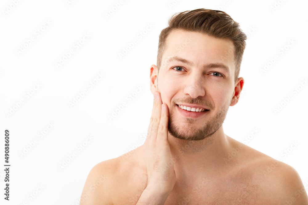 Portrait of a naked young man with stubble on a white background. Portrait of a naked young man with stubble on a white background.