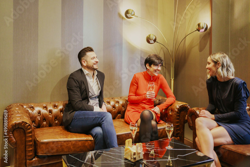 Group of happy friends enjoying meeting in luxury restaurant