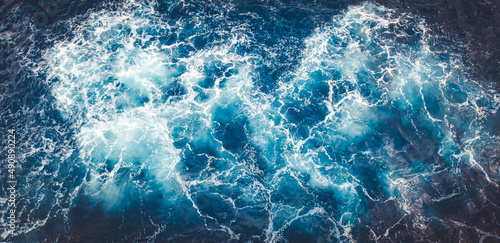 Wall Mural Top view of beautiful foamy textured sea waves in a blue water