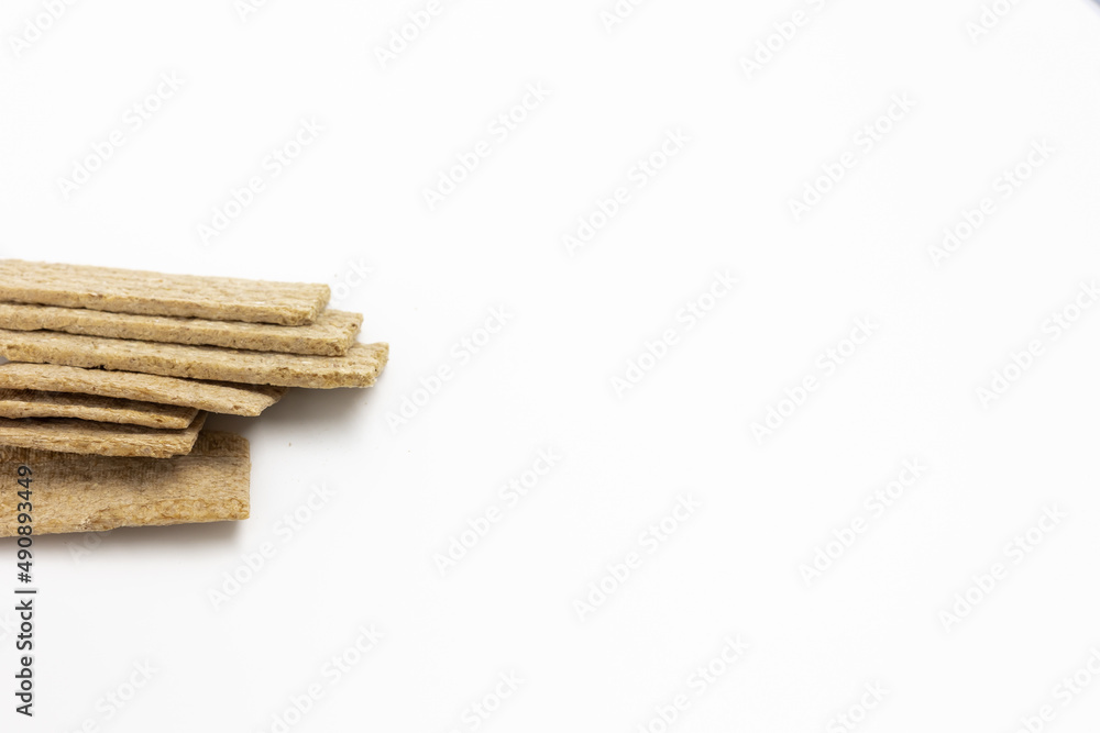 Obraz premium Several dry wheat diet light thin breads on a white background isolated