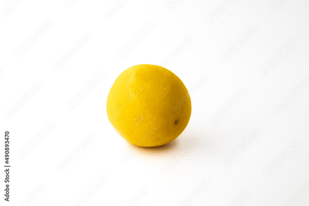 One whole citrus fruit a hybrid of orange and lemon in light orange color with shadow on a white background One whole citrus fruit a hybrid of orange and lemon in light orange color with shadow on a white background