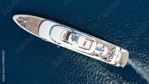 Aerial drone ultra wide photo of luxury yacht with wooden deck and helipad anchored near port of Port of Fontvieille in deep blue sea, Monaco, France © aerial-drone