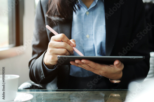 close up of the hand of a business woman holding an ipad at work
