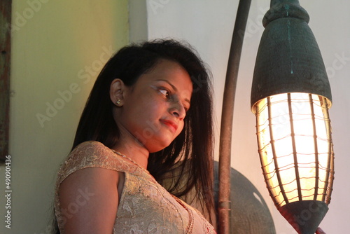A charming young woman in a traditional red and yellow dress with a gold embroidered sari