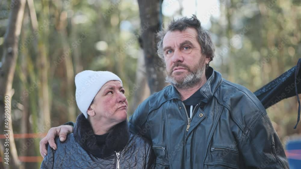A homeless man and woman giving an interview in the winter in the woods. A homeless man and woman giving an interview in the winter in the woods.