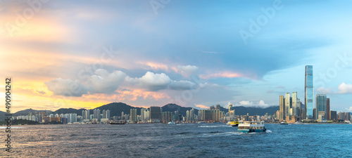 panorama view of cityscape of buildings between tsim sha tsui and Tsing Yi Island along Victoria Harbour, Hong Kong during sunset