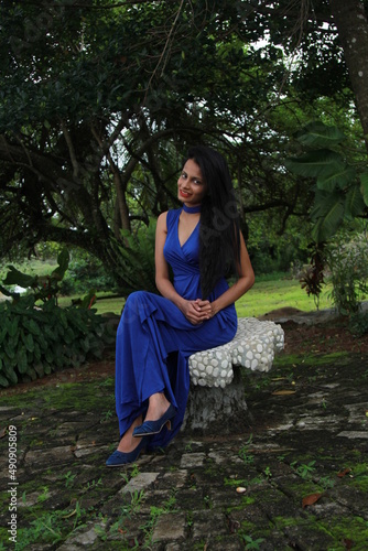 Beautiful girl in a long blue dress. A young woman of Asian descent with black hair