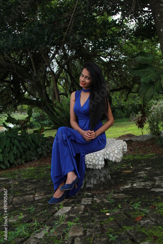 Beautiful girl in a long blue dress. A young woman of Asian descent with black hair