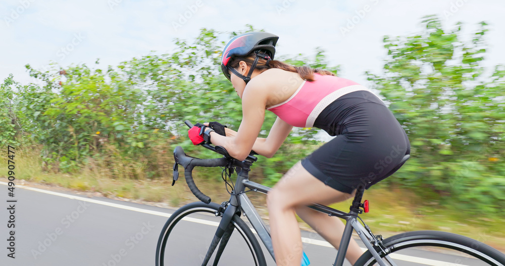 Asian young woman ride bicycle