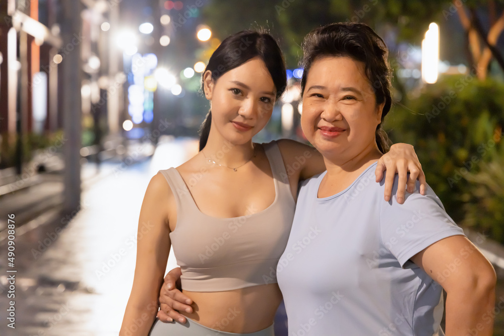 Happy family with mother and daughter doing evening working out together Happy family with mother and daughter doing evening working out together