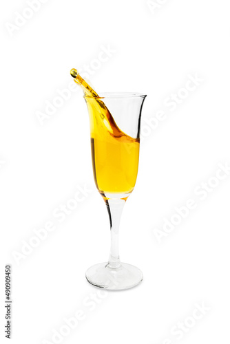 Transparent wineglass with splash of yellow liquid, isolated on white background