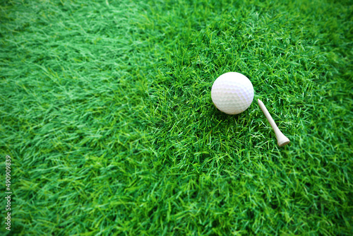 Golf ball close up on green grass on blurred beautiful landscape of golf background.Concept international sport that rely on precision skills for health relaxation...