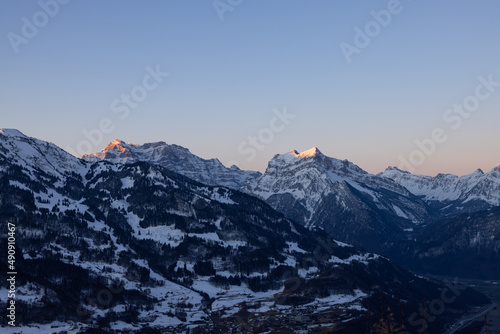 A mountain in the Swiss Alps beautifully set in scene by the morning sun. A majestic sight from a mountain that looks like the Matterhorn. © Philip