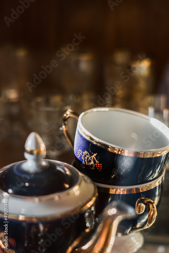 Antique old service. Old service in a sideboard at a summer cottage. collection of tea porcelain service, cobalt gilding, service behind the flow