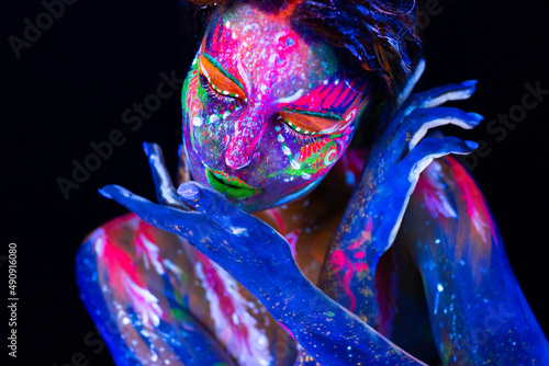 Portrait of a girl painted in fluorescent powder