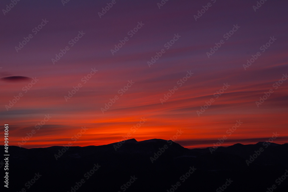 An amazing Sunrise over the mountains. Panoramic view of gorgeous pink sunrise.