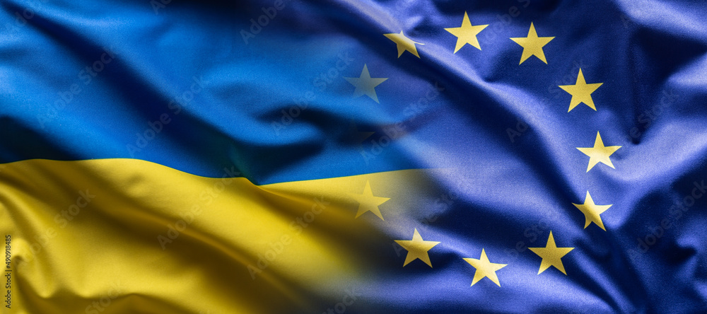 Ukrainian and the EU flag blending into each other as European Union leans towards the membership of Ukraine - obrazy, fototapety, plakaty 