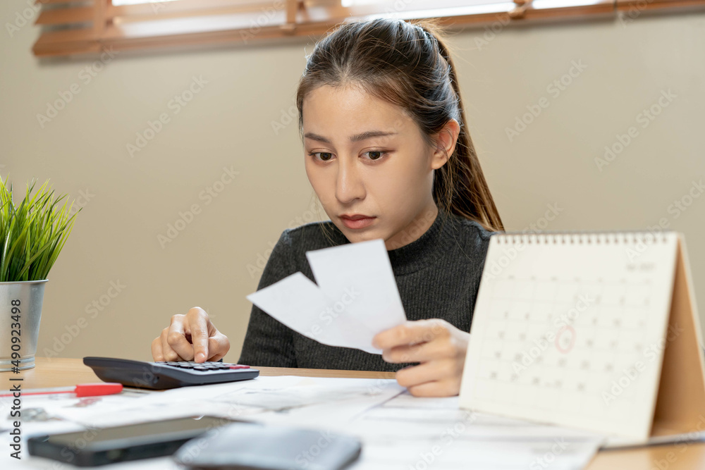 Financial owe asian woman, female sitting on floor home, stressed and confused by calculate expense from invoice or bill, have no money to pay, mortgage or loan. Debt, bankruptcy or bankrupt concept. Financial owe asian woman, female sitting on floor home, stressed and confused by calculate expense from invoice or bill, have no money to pay, mortgage or loan. Debt, bankruptcy or bankrupt concept.