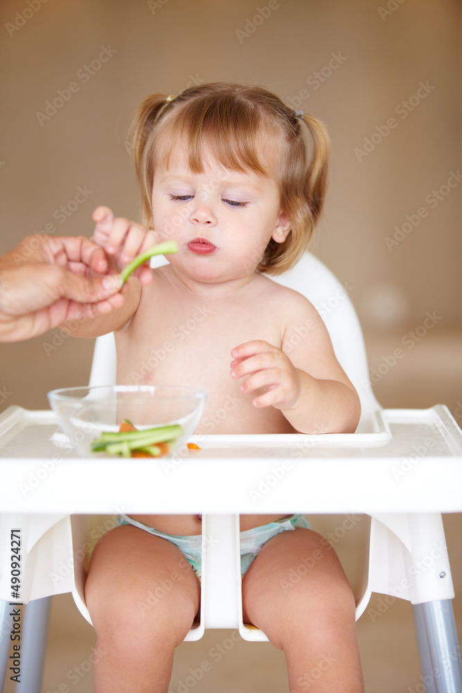 Healthy snacking. A cute little girl being fed by her mother. Healthy snacking. A cute little girl being fed by her mother.